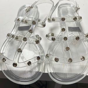Aldo woman’s sandals clear in color with glass stones on straps.